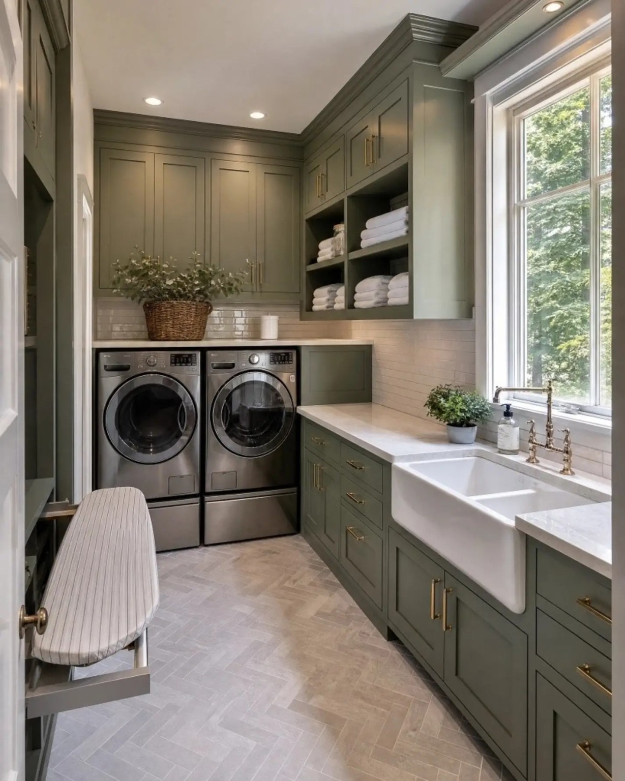 Laundry room with green cabinetry